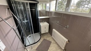 Shower, hair dryer, towels, toilet paper