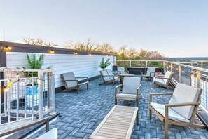 A rooftop patio with outdoor seating, string lights, and a view of the landscape. - 360° DT views, 8 min to Broadway, 5 min to Gulch (Nashville)