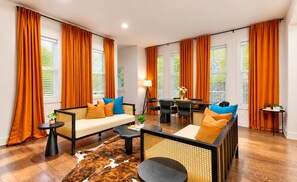 A modern living room with a sofa, armchairs, a coffee table, and a dining area. - Honky Tonk Haven | 13 Beds•5 Baths• Game Room! (Nashville)