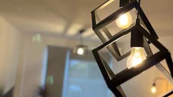 A modern interior with geometric light fixtures and a visible door in the background.