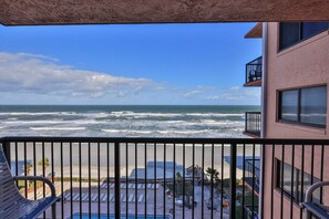 A balcony with a view of the ocean and beach. - Oceanfront Bliss – 2BR/2BA Condo with Stunning Views @ Sunrise (New Smyrna Beach)