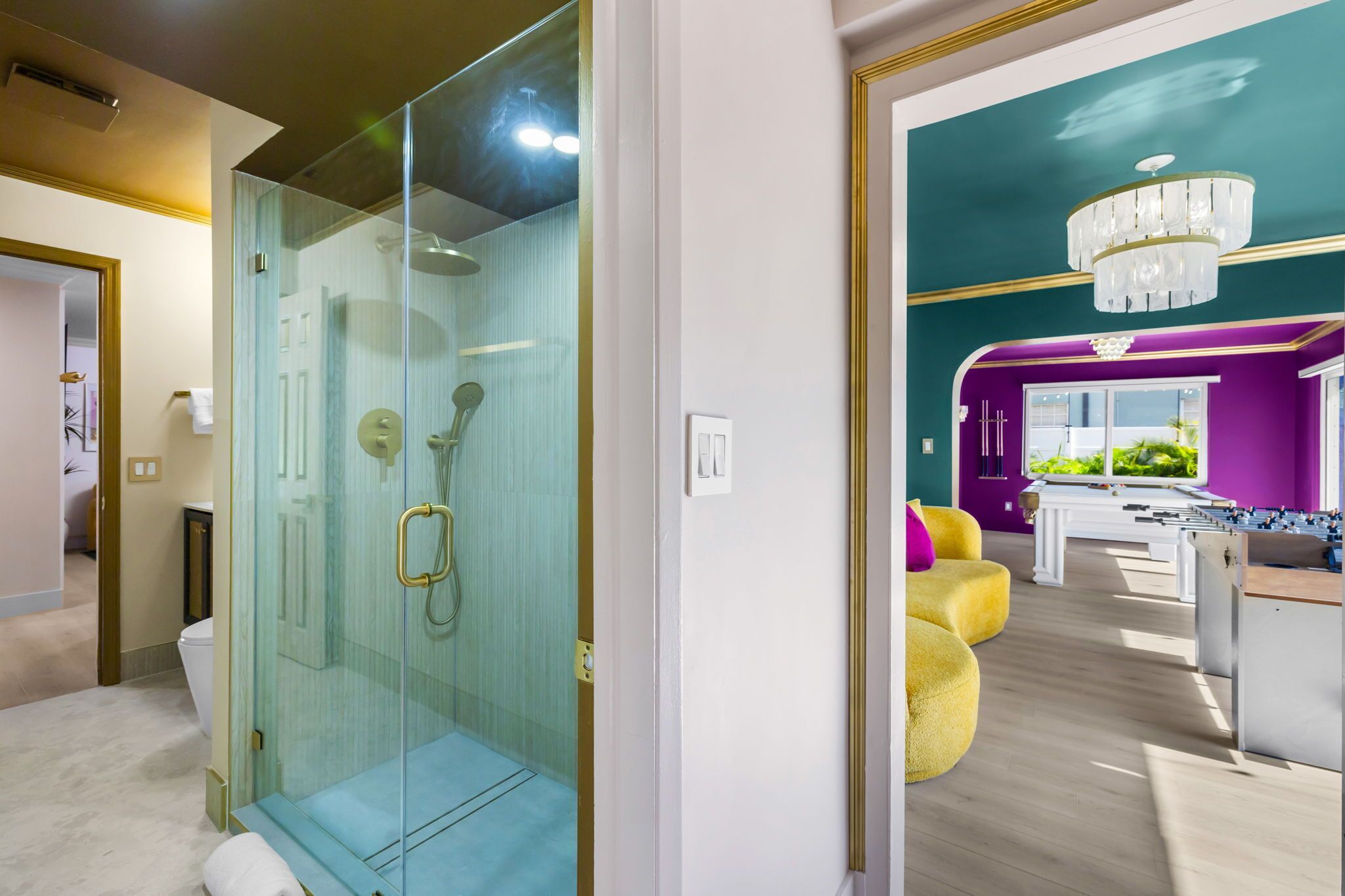A modern bathroom with a glass-enclosed shower and a visible toilet.