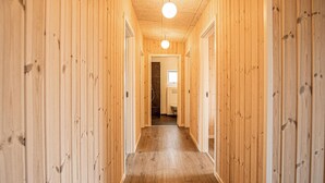 A wooden hallway with a wooden floor and doors on both sides. - Gorgeous home in Grenaa with sauna (Grenaa)