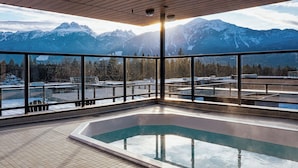 A hot tub with a view of snow-capped mountains.