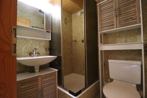 A bathroom with a sink, toilet, and shower. - Outside: studio for 2 people with balcony overlooking the Matterhorn, located in a residence with el (St-Luc)