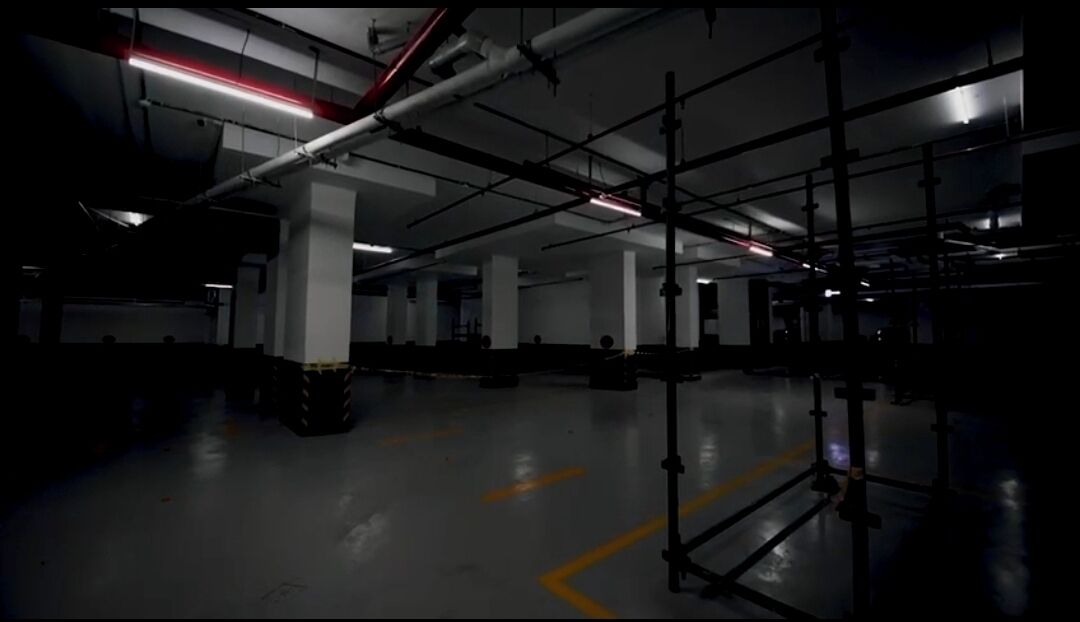 A spacious indoor area with concrete floors and industrial-style lighting.