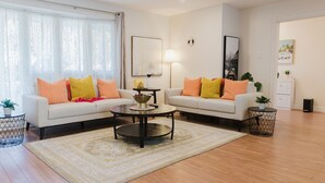 A living room with two sofas, a coffee table, and a lamp. - Sydney Retreat | 3BR, 2 Bath Home with Deck & BBQ (Sydney)