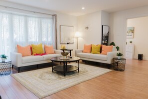 A living room with two sofas, a coffee table, and a lamp.