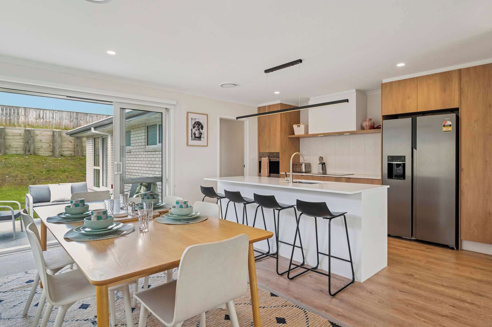 Life on the Rise has a modern and spacious kitchen and dining area opening out to the back patio.