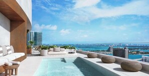 A rooftop pool area with lounge seating and a view of the city skyline. - King Deluxe Studio (Miami)