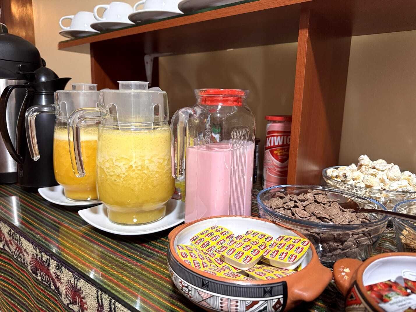 A buffet table with various food items and beverages.