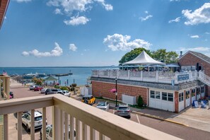 A waterfront property with a covered patio, a brick building, and a view of the sea. - Downtown Bayfield Lodging in Historic Building (Bayfield)