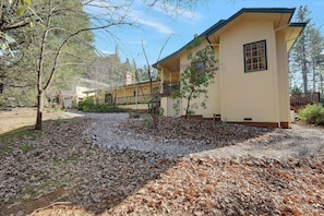 A two-story building with a balcony and a covered porch area. - Pine Grove Retreat for 10 | Game Room + Fire Pit (Pine Grove)