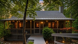 A house with a porch, a wooden deck, and a small garden area with a tree and plants. - New listing! Cabin Mountain Escape Near Atlanta -  Friends • Family • Romantic (Jasper)