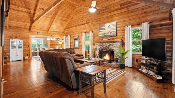 A log cabin interior with a fireplace, a television, and a sofa. - New listing! Cabin Mountain Escape Near Atlanta -  Friends • Family • Romantic (Jasper)