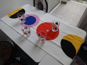 Ein Tisch mit weißer Tischdecke und bunten, kreisförmigen Mustern.