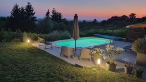A backyard with a swimming pool, patio furniture, and potted plants. - Hilltop house with jacuzzi, sauna, pool, barbecue, and orchard (Voloder)