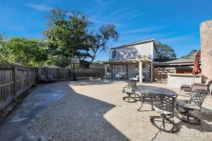 A backyard with a patio area, outdoor seating, and a basketball hoop. - Creekhaven Getaway w/ Basketball Court | Sleeps 16 (Houston)