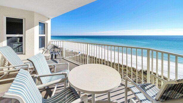 A balcony with a view of the beach, lounge chairs, and a small table. - Gulf Front-Amazing Views! Close to Dining & Shopping Crystal Dunes 404 (Destin)