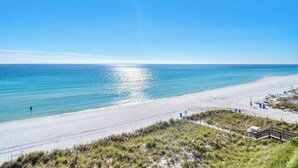 A beach with a clear sky, sandy shore, and a person walking. - Gulf Front-Amazing Views! Close to Dining & Shopping Crystal Dunes 404 (Destin)