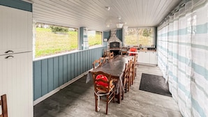 A long dining table with chairs, a kitchen area, and a large window with a view of the outdoors. - Pet friendly home in Saint-Denis-le-Vêtu with WiFi (Saint-Denis-le-Vêtu)