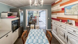 A kitchen with a dining table, chairs, a refrigerator, and a microwave. - Pet friendly home in Saint-Denis-le-Vêtu with WiFi (Saint-Denis-le-Vêtu)