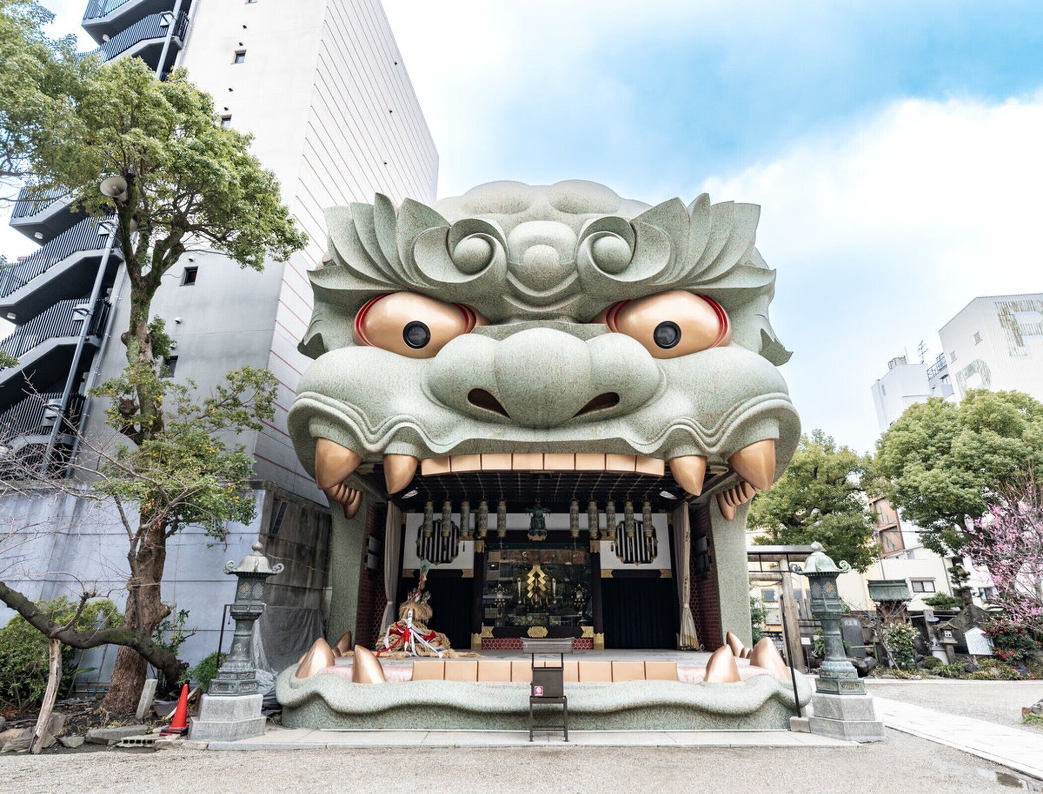 A building with a large, ornate dragon head sculpture at the entrance.