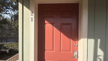 A red door with a number 21 on the wall to the left.