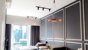 A modern hotel room with a large window, a dining area, and a kitchen. - Axon Residence Bukit Bintang by Fie (Kuala Lumpur)