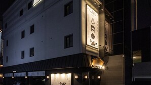 Un edificio con un letrero que dice 'Cave Hotel' y un estacionamiento al frente.