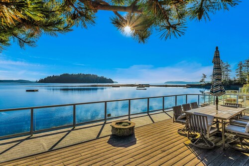 Waterfront home with private hot tub, game room with game tables, and water toys