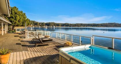 Waterfront home with private hot tub, game room with game tables, and water toys