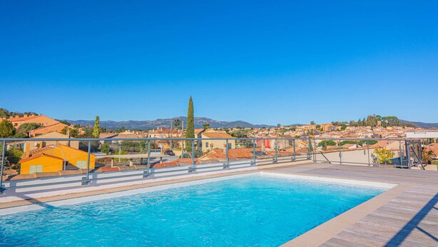 A swimming pool with a view of a town and mountains in the background. - 4-STAR APARTMENT – 2 BEDROOMS – COGOLIN – SWIMMING POOL – CLOSE TO THE TOWN CENTRE (COGOLIN)