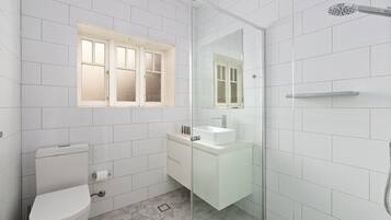 Un baño moderno con inodoro, lavamanos y ducha.