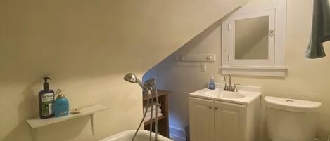 A bathroom with a bathtub, a sink, and a toilet.