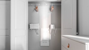 A bedroom with a bed, a wardrobe, and a built-in wardrobe with hanging space for towels. - Blueground | Chevy Chase, rooftop, nr Rock Creek Park (Chevy Chase)