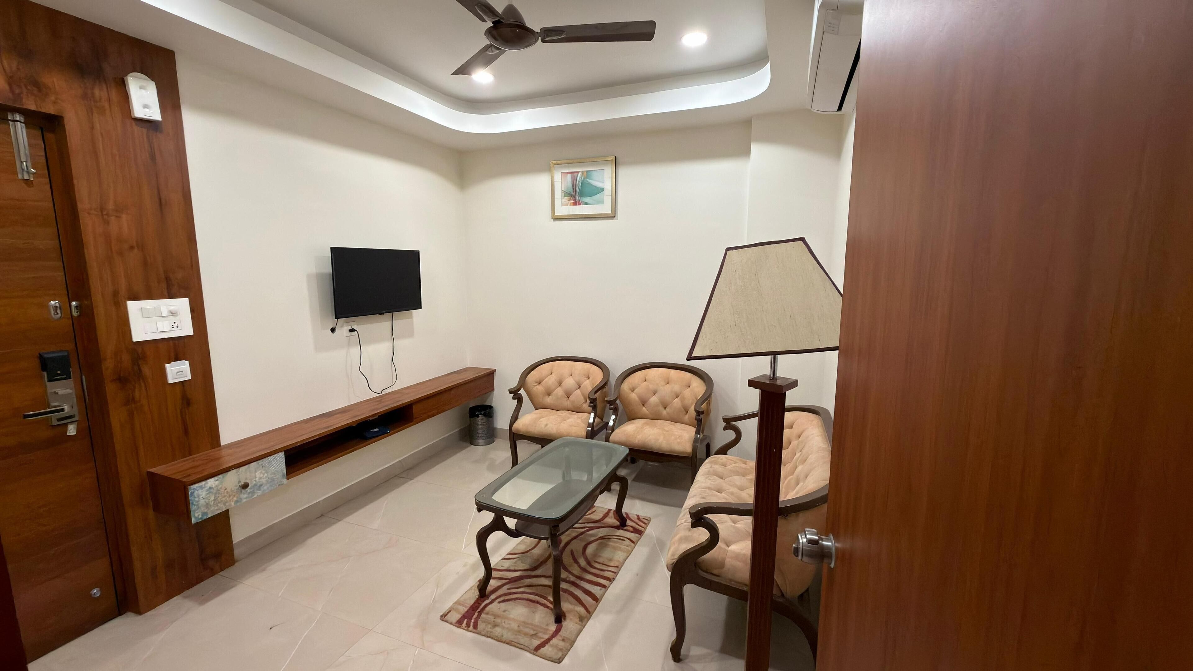 Luxury Suite | Living area | 32-inch LED TV with digital channels