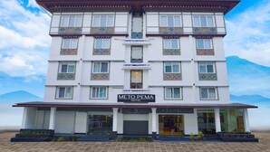 A multi-story hotel with a sign reading "METO PEMA HOTEL". - Meto Pema Hotel  (Phuntsholing)