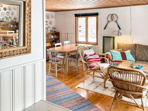 A cozy room with a dining table, chairs, a sofa, and a mirror. - 8 Person Holiday Home in Lottorp (Löttorp)
