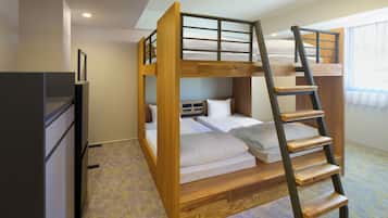A bunk bed room with a wooden ladder, a desk, and a window with curtains.