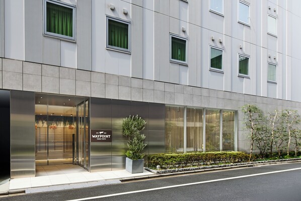 A modern building with a glass entrance, a sign reading 'WAYPOINT,' and a potted plant outside. - WAYPOINT TSUKIJI TOKYO (Tokyo)