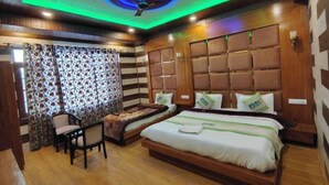 A hotel room with a wooden ceiling, a bed with a headboard, a chair, and a small table. - Hotel Golden Eye (Srinagar)