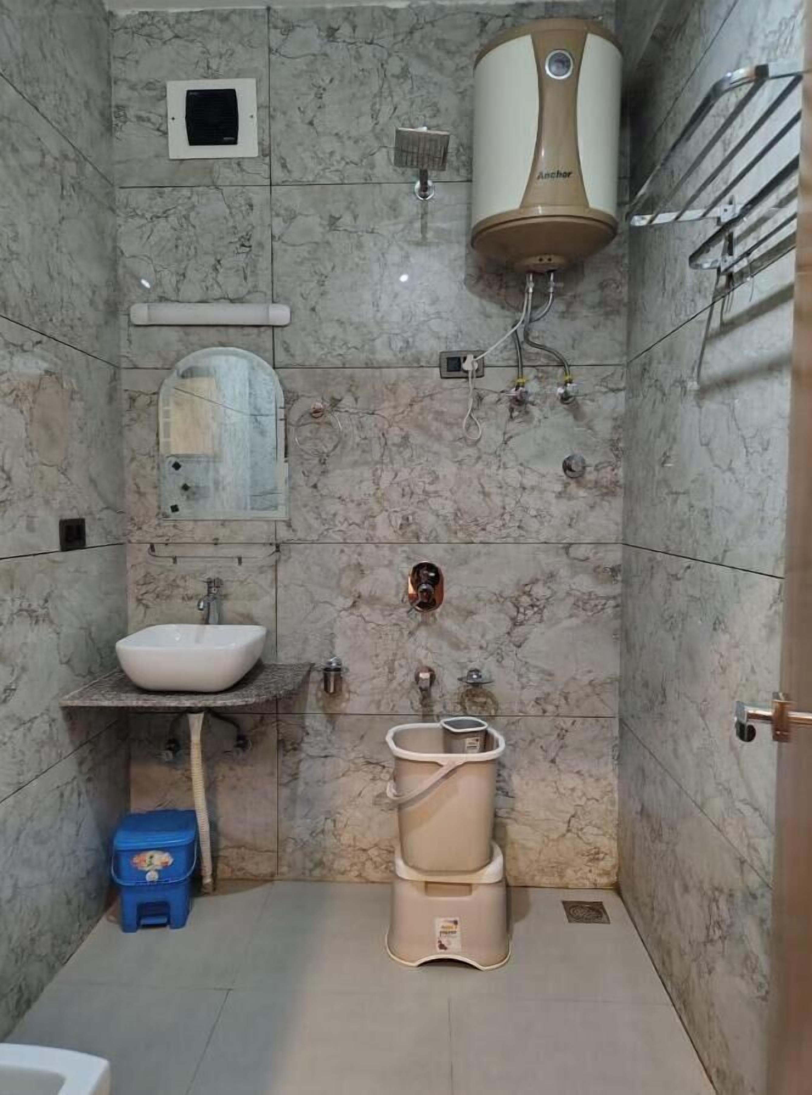A bathroom with a sink, toilet, and shower.