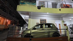 A car parked inside a building with a balcony and a sign that reads "ANDAMAN CREEK".