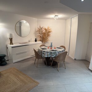 A dining area with a round table, chairs, a mirror, and a ceiling fan. - 200 M TO THE SANDY BEACH AND SEA VIEW!!! (Antibes)