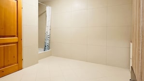 A bathroom with a wooden door, tiled walls, and a shower area. - Spacious Garden Villa | 16 Guests (Vienna)