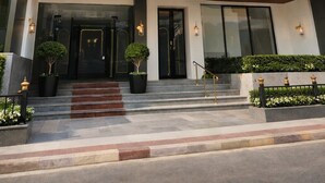 A multi-story hotel named "The Prominence" with a classic architectural design, featuring a grand entrance, multiple balconies, and a well-maintained exterior. - The Prominence Premium Hotel & Banquet  (Greater Noida)
