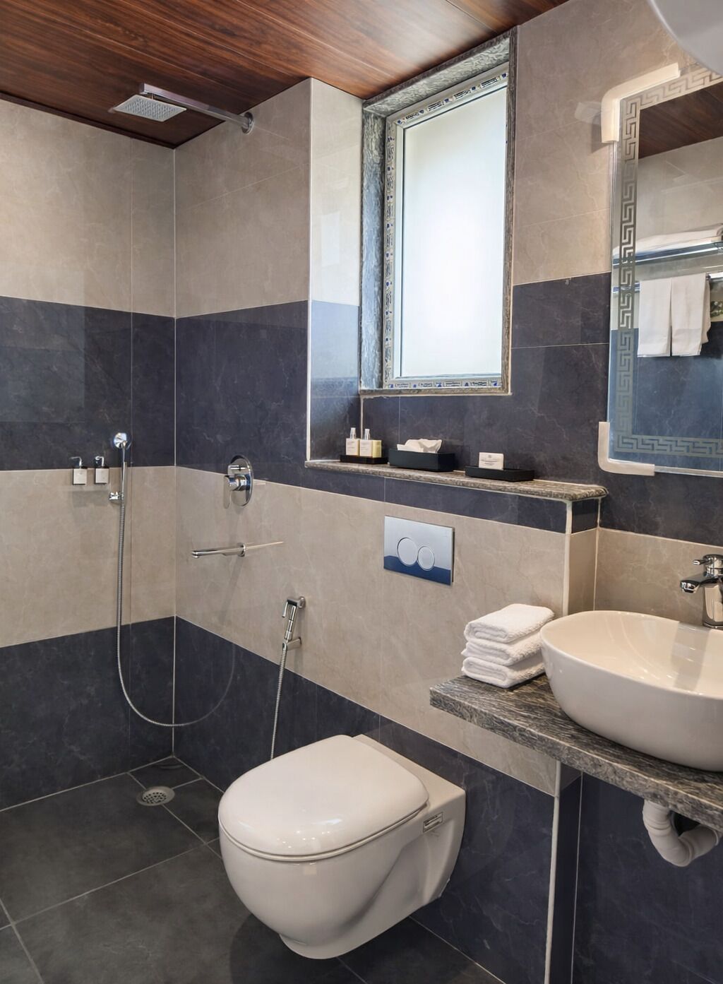 A modern bathroom with a shower, toilet, and sink.