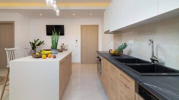 Deluxe Suite, Balcony, Sea View | Private kitchen | Stovetop, electric kettle, toaster, high chair