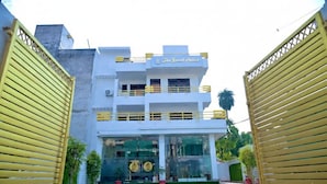 A two-story building with a sign reading "The Grand Palace." - THE GRAND PALACE (Prayagraj)